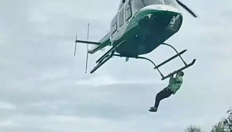 Düğünde helikoptere binmesine izin verilmeyen adam, helikoptere tutunarak havalandı