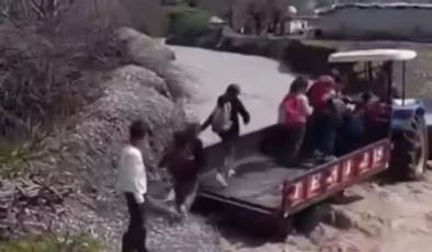 Silopi’de eğitim mesaisi: Debisi yükselen dereyi traktör sırtında aştılar!